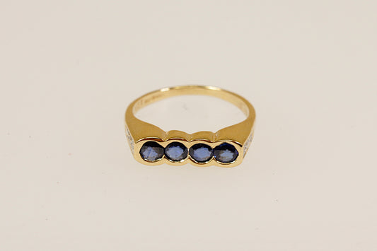 18ct four Sapphire gemstone and diamond set shoulders ring Sheffield hallmarks for 18ct gold and dated 1994 UK finger size M this ring is an ideal pinky little finger ring unisex male or female.
