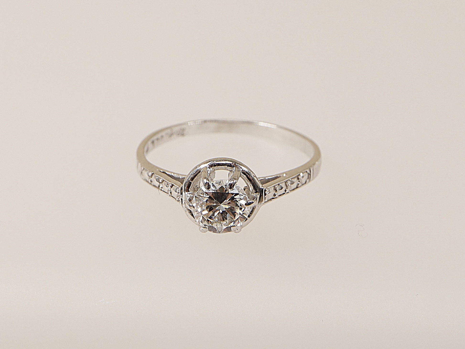 An 18ct white gold diamond solitaire ring with a central diamond set in a six-claw crown setting, surrounded by smaller diamonds on the shoulders. This ring would make an ideal engagement ring for your loved one! 
Diamond diameter: 5mm, Diamond weight: 0.50ct (estimated), UK Finger size N.