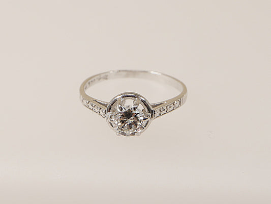 An 18ct white gold diamond solitaire ring with a central diamond set in a six-claw crown setting, surrounded by smaller diamonds on the shoulders. This ring would make an ideal engagement ring for your loved one! 
Diamond diameter: 5mm, Diamond weight: 0.50ct (estimated), UK Finger size N.