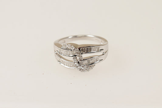This stunning 9ct white gold cluster ring features 2 wave like shaped gold bands  that are encrusted with baguette Diamonds (32 baguette diamonds in total), There is a further 14 round diamonds that are set into a rope design , the ring has Birmingham hallmarks, UK finger size N. 