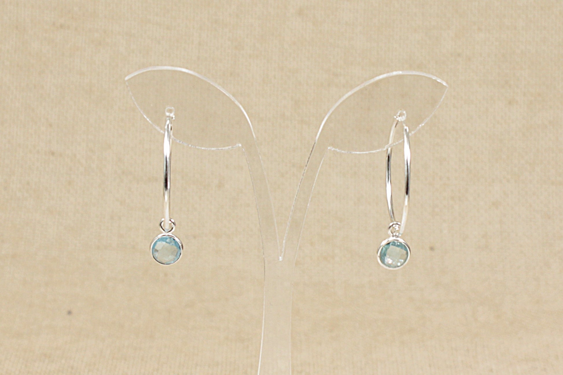 silver hoop earrings with blue topaz dropper rear view
