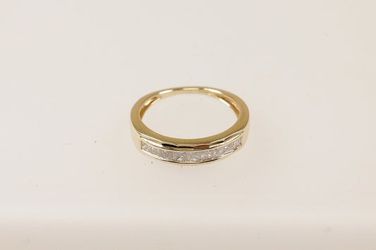 A 9ct gold band ring with channel-set princess cut diamonds around the middle section, The ring is in excellent condition and inside the band it has Birmingham hallmarks and the makers mark CR. UK Finger size N. 