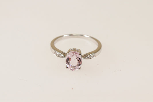 A 9ct white gold solitaire ring with an oval pink 'Rose de France' Amethyst centerpiece and diamond accents on the shoulders, displayed against a white background.