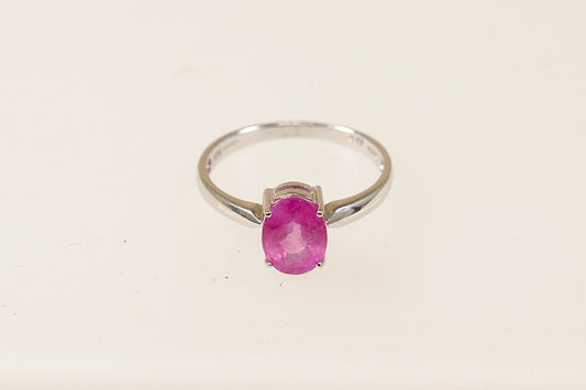 A 9ct white gold ring with an oval pink Sapphire centerpiece, displayed against a white background.