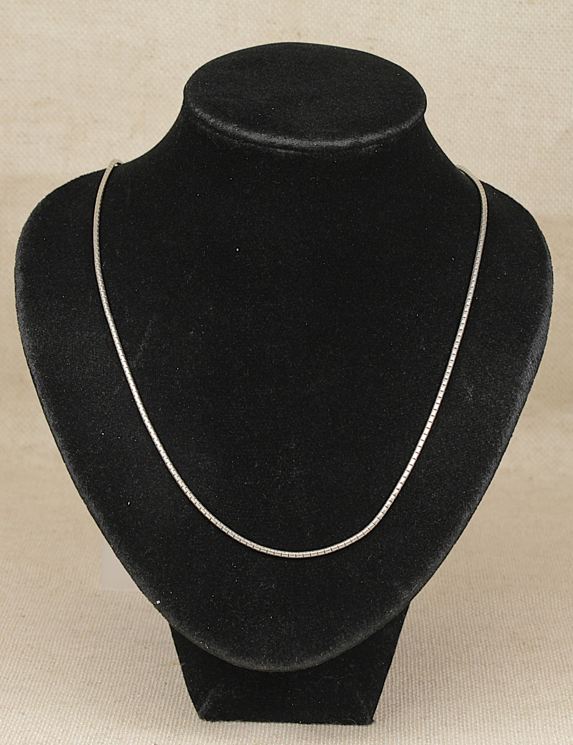 Authentic Pandora Sterling Silver Snake Chain Necklace on a black necklace bust on a beige background