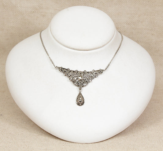 Silver art deco marcasite necklace on a white jewelry display