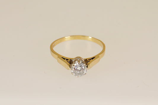 18ct Gold diamond solitaire ring on a beige background