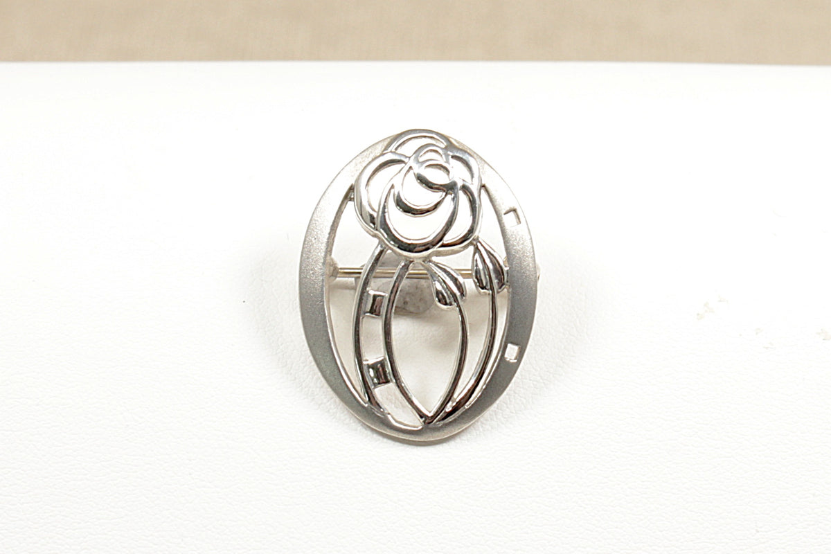 A beautiful handcrafted Silver brooch by the renowned designer Kit Heath the design are often inspired by nature and classic movements like Art Nouveau  It is in excellent condition and stamped KH and 925 for sterling silver.
