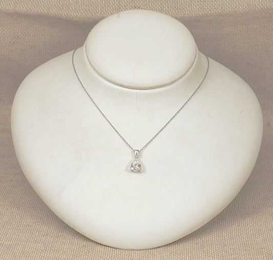 Silver necklace with a pendant on a white jewelry display