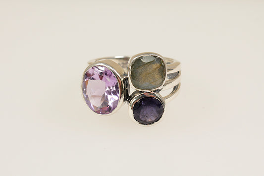 This stunning new Silver ring features 3 large faceted gemstones, Amethyst, Blue Iolite and Labradorite. Set in a stylish and contemporary split band design, it is a bold and artistic statement piece. UK finger size O.