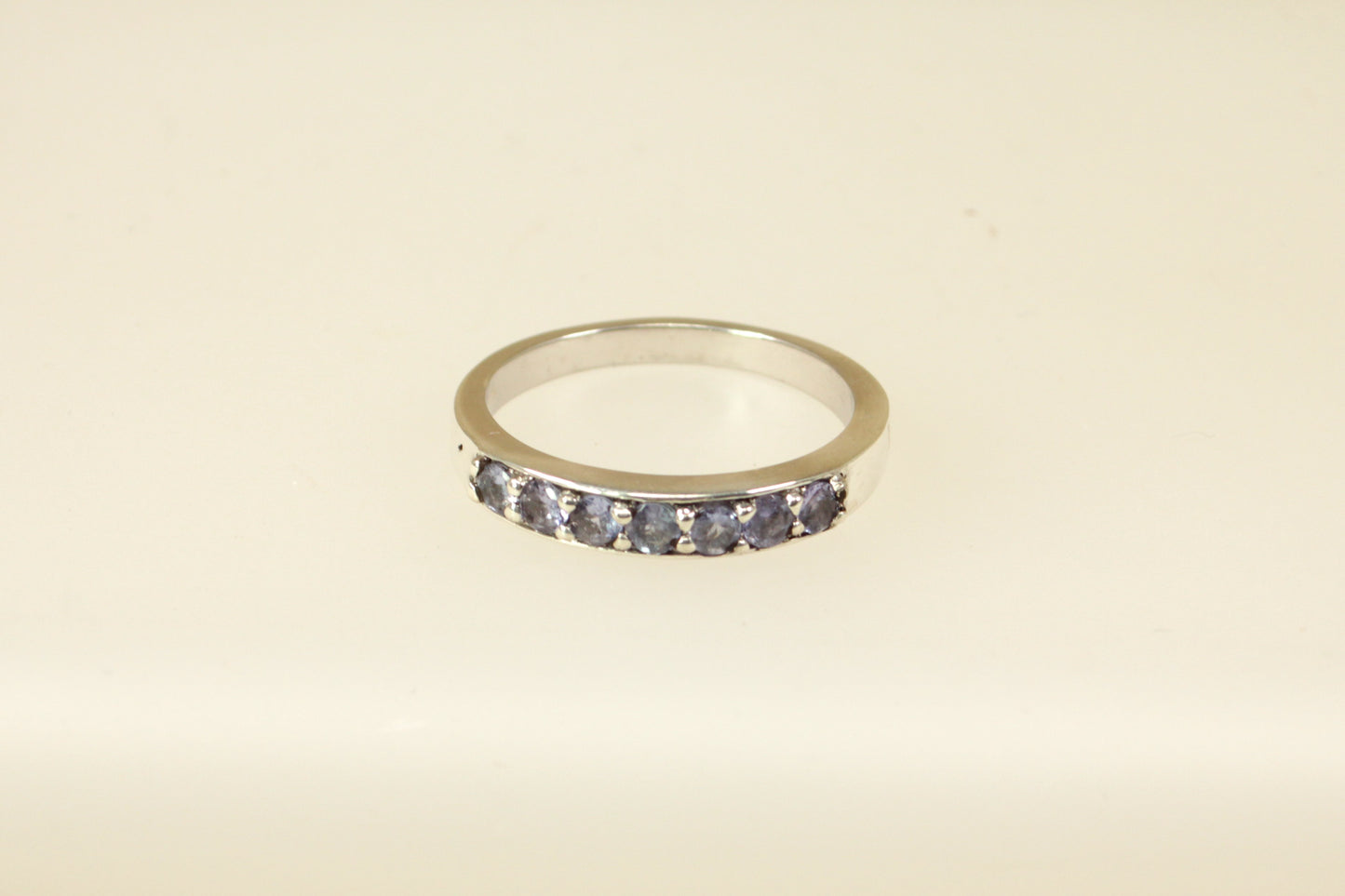 This pretty silver ring has 7 round Iolite gemstones set in handcrafted silver across the band. It is in excellent condition and inside the band it is stamped 925 for sterling silver. Band width: 4mm

UK Finger size: S