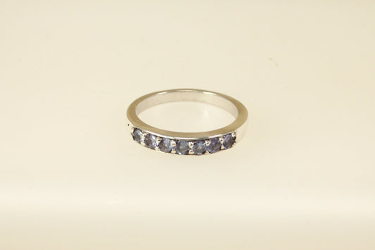 This pretty silver ring has 7 round Iolite gemstones set in handcrafted silver across the band. It is in excellent condition and inside the band it is stamped 925 for sterling silver. Band width: 4mm

UK Finger size: S