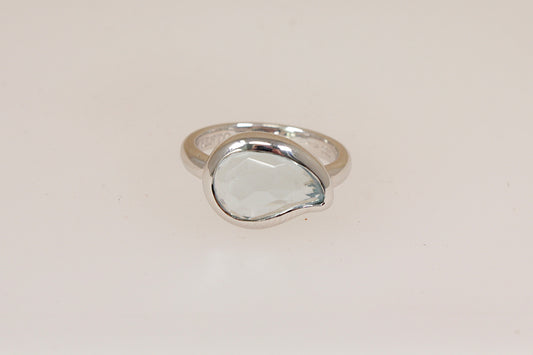 Silver designer ring by Italian maker 'Ti Sento' with a pale blue sem-precious gemstone on a light beige background