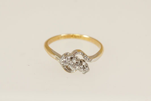 A vintage 18ct gold and platinum diamond twist ring with an estimated 0.15 carat diamonds, circa 1930's, uk finger size O. 